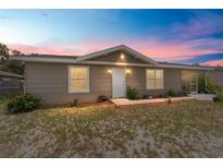 Charming single-story home featuring neutral siding, brick accents, white trim and front door, and well-maintained landscaping at 8940 Se 87Th Ter, Ocala, FL 34472