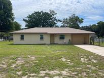 Charming single story home featuring a well-maintained lawn and attached single car garage at 145 Ne 71St Ave, Ocala, FL 34470