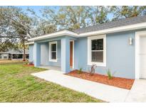 Charming single-story home with blue exterior and inviting front porch, enhancing curb appeal at 15369 Sw 38Th Pl, Ocala, FL 34481