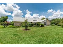 Charming single-story home boasts a manicured lawn and beautiful landscaping, creating a welcoming curb appeal at 2640 Sw 36Th Ln, Ocala, FL 34471