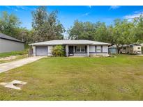 Charming single-story home featuring a well-maintained front yard with mature trees and a cozy entrance at 329 Larch Rd, Ocala, FL 34480