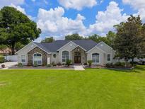 Charming single-story home with stone accents, arched windows, and a lush green lawn at 3883 Se 51St Ct, Ocala, FL 34480