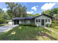 Charming single-story home featuring a well-manicured lawn, covered carport and a welcoming front entrance at 11430 Se 54Th Ave, Belleview, FL 34420