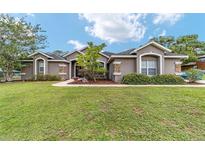 Charming home with well-manicured lawn, stone accents, and inviting walkway at 2151 Se 59Th St, Ocala, FL 34480