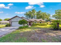 Charming single-story home with a well-maintained front yard and inviting curb appeal with a garage and lovely landscaping at 5581 Se 35Th St, Ocala, FL 34480