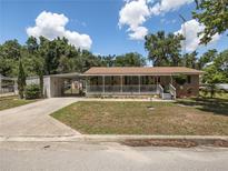 Charming home featuring a covered front porch and spacious front yard at 5915 Se Holly Rd, Belleview, FL 34420