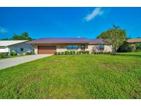 Charming brick single-story home with well-manicured lawn and a durable metal roof at 6142 Se 37Th Ter, Ocala, FL 34480