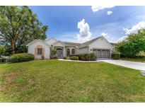 Charming single-story home with a well-manicured lawn and a two-car garage, perfect for comfortable living at 8128 Sw 117Th Loop Loop, Ocala, FL 34481