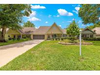 Charming one-story home with lush landscaping, well-manicured lawn, and a welcoming front porch at 8351 Sw 93Rd Ln # C, Ocala, FL 34481