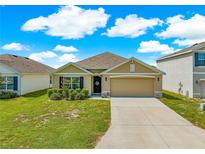 Charming single-story home with well-maintained lawn and a two-car garage on a beautiful sunny day at 8685 Sw 49Th Cir, Ocala, FL 34476