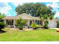 Charming single-story home featuring a well-manicured lawn and nicely landscaped front yard at 8896 Sw 116Th Place Rd, Ocala, FL 34481