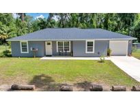 Charming single-story home with well-maintained lawn and inviting front entrance at 1133 Nw 122Nd Pl, Citra, FL 32113