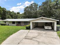 Charming one-story home featuring brick accents and a covered carport at 2155 Nw 27Th Ave, Ocala, FL 34475