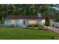 Charming single-story home featuring a manicured lawn, flower beds and a welcoming entryway at 3515 Ne 43Rd Pl, Ocala, FL 34479