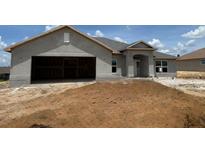 Charming single-Gathering home featuring an attached two-car garage and an inviting front entrance at 4340 Nw 1St Ave, Ocala, FL 34475