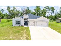 Charming single-story home featuring a two-car garage and well-maintained landscaping at 5239 Sw 114Th Street Rd, Ocala, FL 34476