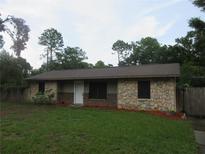 Charming single-story home with stone accents and a well-manicured lawn at 6141 Nw 64Th Ct, Ocala, FL 34482