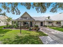 Charming home featuring meticulous landscaping, a neutral facade, and an attached one car garage at 8841 Sw 91St St # A, Ocala, FL 34481