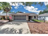 Charming single-story home featuring a screened garage, landscaped yard, and inviting curb appeal at 9069 Sw 91St Cir, Ocala, FL 34481