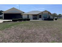 Charming single-story home featuring a unique attached aircraft hangar at 9700 Se 72Nd Ave, Ocala, FL 34472