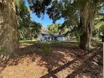 Charming single-story home surrounded by mature trees and lush landscaping at 14 Count Fleet Dr, Ocala, FL 34482