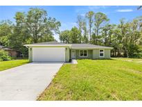 Charming single-story home features a well-manicured lawn and an attached two-car garage at 1708 Nw 27Th Ave, Ocala, FL 34475