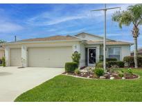 Charming single-story home with a well-manicured lawn, a two-car garage and attractive landscaping at 1768 Sw 156Th Ln, Ocala, FL 34473