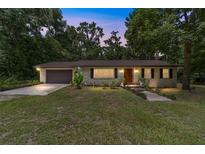 Charming single-story home featuring a well-manicured lawn, neutral paint, and a two-car garage at 19130 Nw 60Th Ave, Reddick, FL 32686