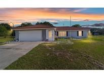 Charming single-story home with a red tile roof, garage, and lovely lawn at 475 Ne 155Th Pl, Citra, FL 32113
