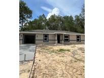 Charming single-story home featuring neutral colors and an attached garage, perfect for modern living at 10375 Se 126Th Ln, Belleview, FL 34420