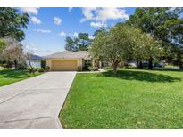 Charming single-Gathering home with well-maintained lawn and mature trees, showcasing a welcoming curb appeal at 4300 Nw 4Th Cir, Ocala, FL 34475