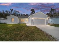 Charming single-story home featuring a well-manicured lawn and an attached two-car garage at 13741 Sw 81St Cir, Ocala, FL 34473