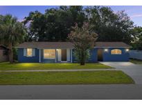 Charming single-story home with blue exterior, well-maintained lawn, and mature landscaping at 14761 Sw 35Th Terrace Rd, Ocala, FL 34473