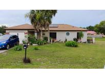 Charming single-story home featuring a well-manicured lawn and mature palm trees at 313 Oak Track Trce, Ocala, FL 34472