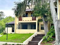 Inviting two-story home with large trees, screened porch, and well-manicured lawn at 3525 E Fort King St # 140, Ocala, FL 34470