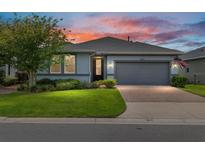 Charming single-story home featuring a two-car garage, well-manicured lawn, and beautiful brick driveway at 4340 Nw 56Th Ct, Ocala, FL 34482