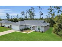 Charming single-story home featuring a well-manicured lawn, attached garage and a classic, neutral-toned exterior at 4501 Sw 159Th Street Rd, Ocala, FL 34473