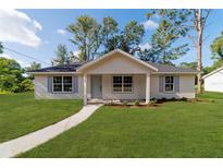 Charming single-story home with a well-manicured lawn, light blue shutters, and a welcoming front porch at 5388 Nw 9Th St, Ocala, FL 34482