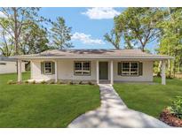 Charming single-story home with a well-manicured lawn and inviting walkway at 5400 Nw 9Th St, Ocala, FL 34482