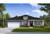 Charming single-story home featuring a two-car garage, well-manicured lawn, and inviting front entrance at 585 Marion Oaks Pass, Ocala, FL 34473