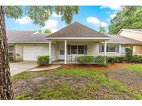 Charming single-story home with a quaint front porch and attached one car garage at 9367 Sw 83Rd Ave # C, Ocala, FL 34481
