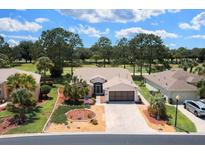 Beautiful home with a well-manicured lawn and landscaping and a brick driveway at 15776 Sw 11Th Terrace Rd, Ocala, FL 34473