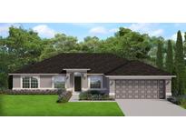 Charming single-story home with a well-manicured lawn and a two-car garage at 180 Willow Rd, Ocala, FL 34472