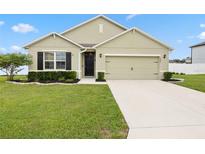 Charming single-story home with a well-manicured lawn, inviting entrance, and two car garage at 2984 Ne 43Rd Rd, Ocala, FL 34470