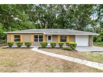 Charming single-story home featuring manicured landscaping and a well-maintained front yard at 3640 Se 131St Ln, Belleview, FL 34420