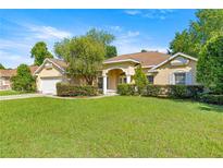 Charming single-story home featuring a well-manicured lawn and mature landscaping at 4555 Nw 6Th Cir, Ocala, FL 34475