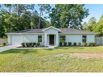 Charming single-story home with a well-manicured lawn and fresh landscaping at 5740 Nw 61St St, Ocala, FL 34482
