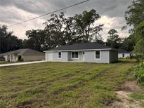 Charming single-story home with light blue exterior, well-maintained lawn, and attached one-car garage at 6422 Nw 62Nd Pl, Ocala, FL 34482
