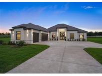 Stunning single-story home with lush lawn, paver driveway and attractive three-car garage at 7041 Ne 22Nd Court Rd, Ocala, FL 34479