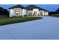 Beautiful single story home with a circular driveway and well manicured landscaping at 7041 Ne 22Nd Court Rd, Ocala, FL 34479